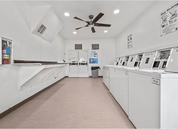 a laundry room with white appliances and a ceiling fan
