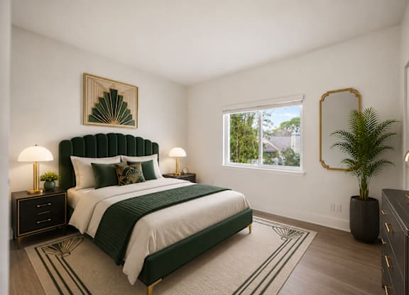A bedroom with a large bed and a green headboard.