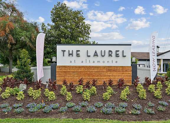 The Laurel at Alta Monroe sign in front of a building.