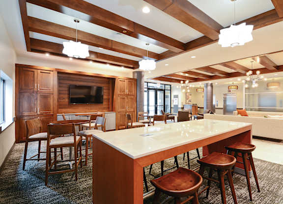 A large kitchen with a long island and wooden cabinets.