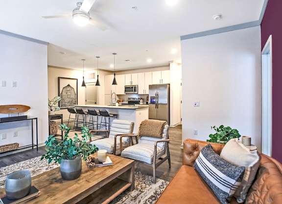 A modern living room with a brown leather couch and a wooden coffee table.