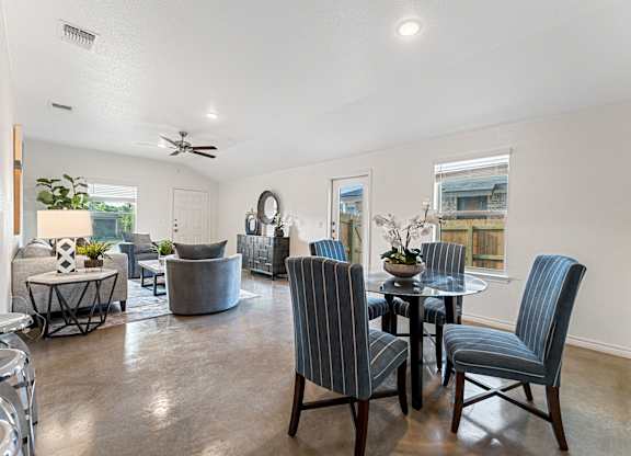 an open living room with a dining room table and chairs