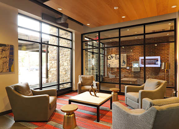 A room with a wooden ceiling and a glass wall.
