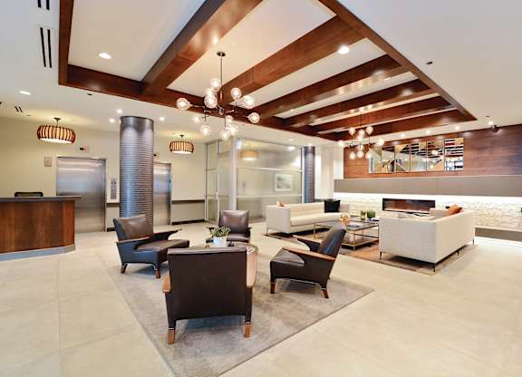 A modern office lobby with a reception desk and comfortable seating areas.