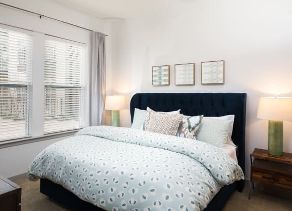 a bedroom with a bed and a ceiling fan