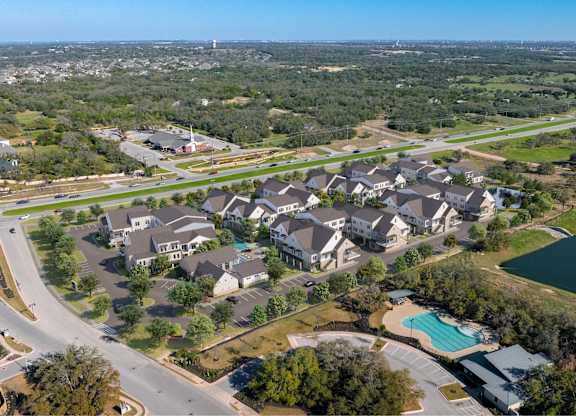 an aerial view of a neighborhood with houses and a swimming pool