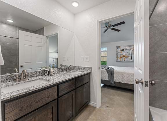 a bathroom with a shower and a sink and a mirror