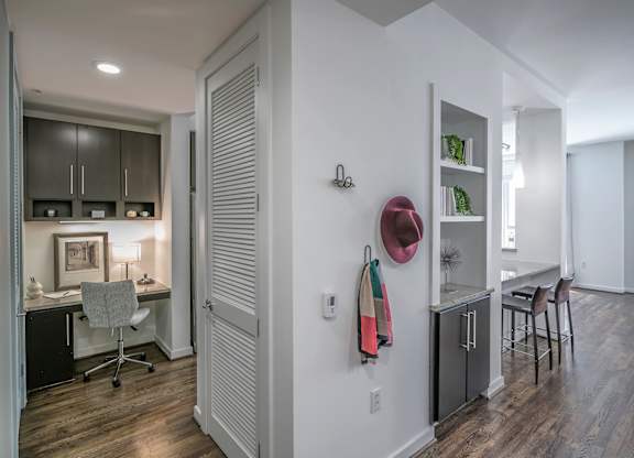 A room with a desk and a chair in it.