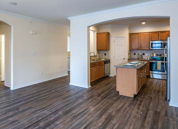 A kitchen with wooden cabinets and a refrigerator.