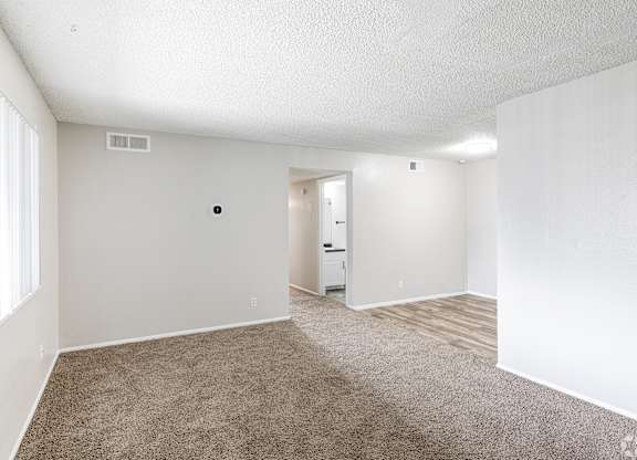 A room with white walls and a carpeted floor.