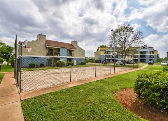 A residential area with houses and a basketball court.
