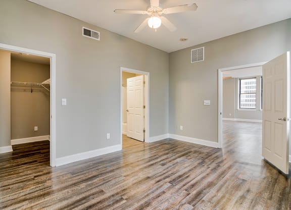 a bedroom with a ceiling fan and a closet