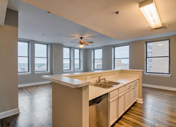 a kitchen with a large island and a ceiling fan