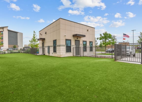 the preserve at ballantyne commons office building with a green lawn and a fence
