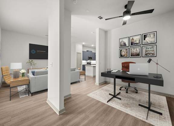 A room with a desk, chair, and a bed.