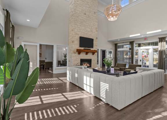 A modern living room with a fireplace and a large couch.