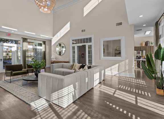 A modern living room with a large sectional sofa and a coffee table.