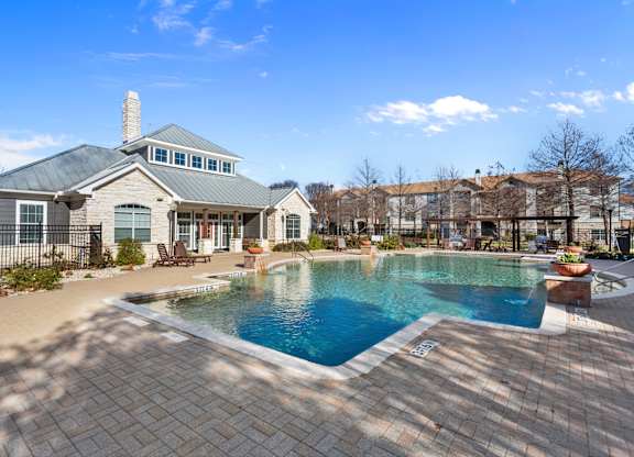 A large house with a pool in the backyard.