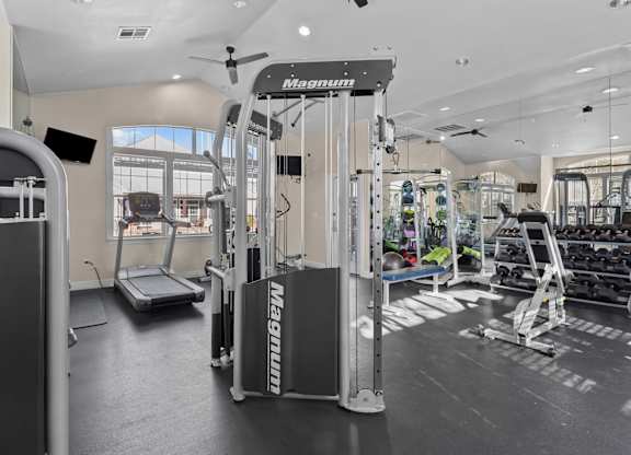 A gym with a Magnum weight machine in the foreground.