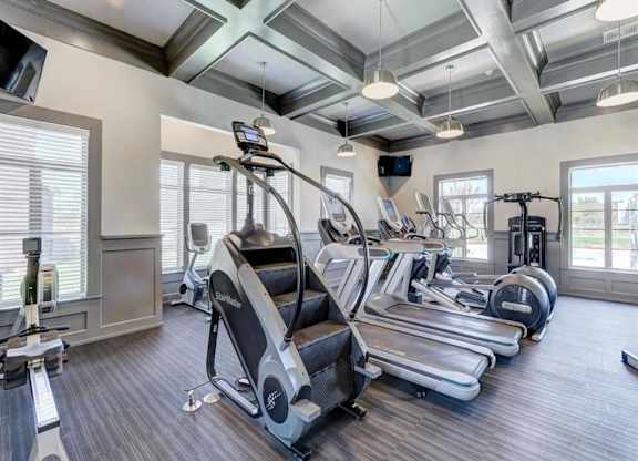 A spacious gym with treadmills, elliptical machines, and other exercise equipment.