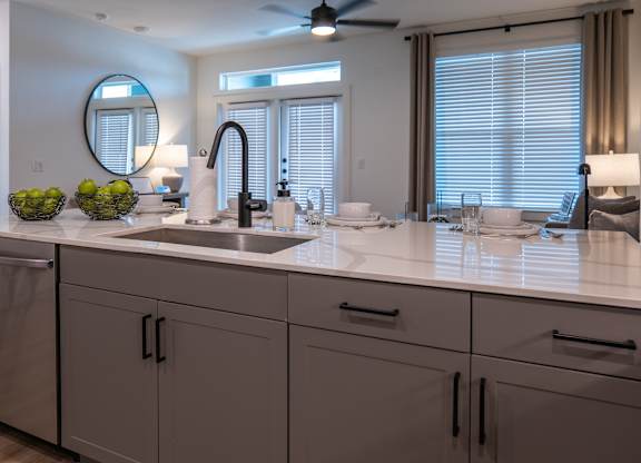 A modern bathroom with a large mirror and a sink.