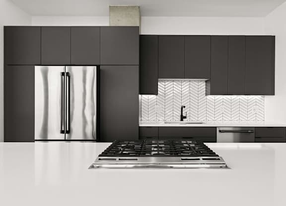 A modern kitchen with a black fridge and a black and white tiled backsplash.