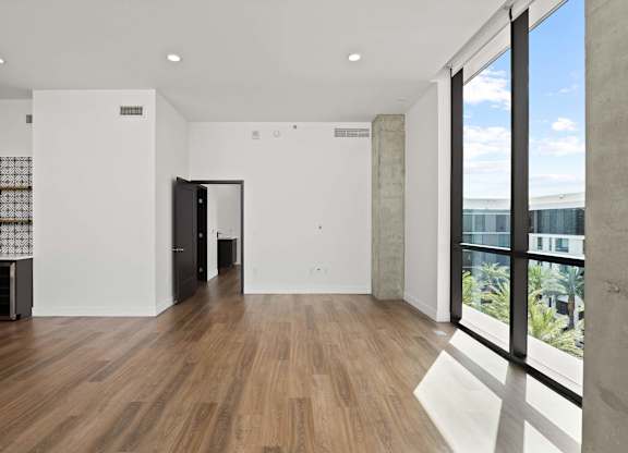 A room with wooden floors and white walls.