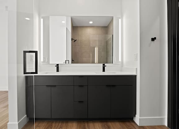 A bathroom with a large mirror and a sink.