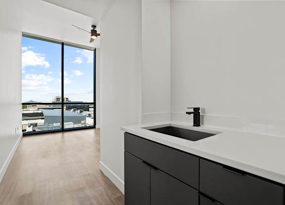 A modern kitchen with a view of the city.