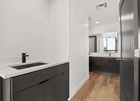 A modern bathroom with a black and white color scheme.