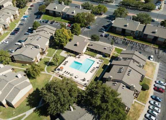 an aerial view of a neighborhood of houses and a swimming pool