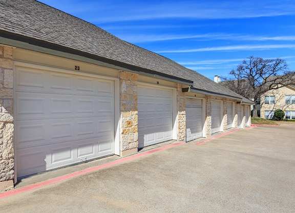 A row of garage doors are closed and numbered 21 to 23.