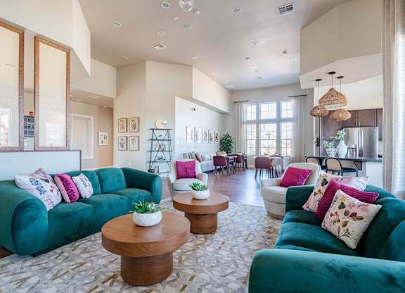 A living room with a green couch and a wooden coffee table.