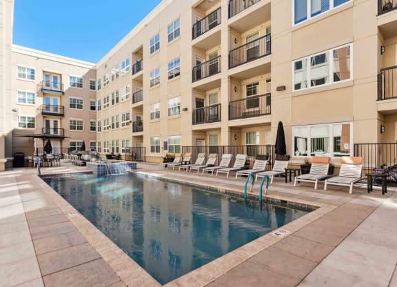 a swimming pool in front of an apartment building