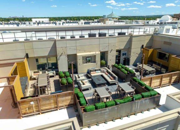 a rendering of a rooftop patio with tables and chairs