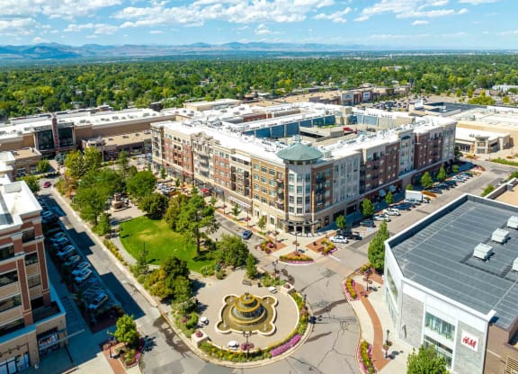 an aerial view of a city with buildings and a fountain