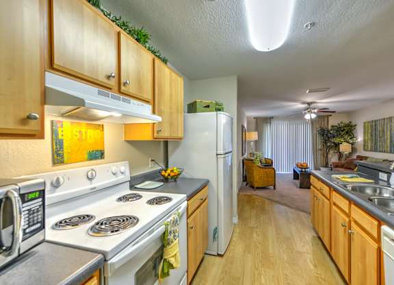 A kitchen with wooden cabinets and a stove top oven.