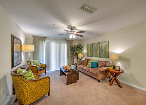 A living room with a brown couch, a chair, and a coffee table.