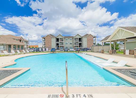 A swimming pool in a residential area with a sign that says "NO DIVING" and "3 FT 4 IN".