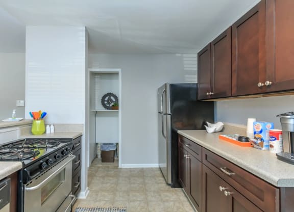 a kitchen with wood cabinets and stainless steel appliances