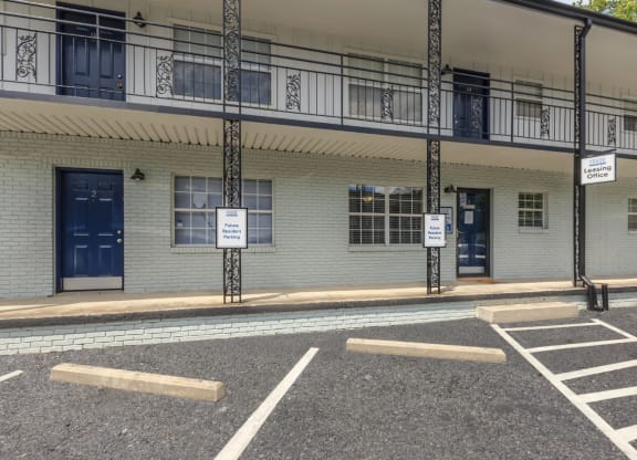 a building with blue doors and windows and a parking lot in front of it
