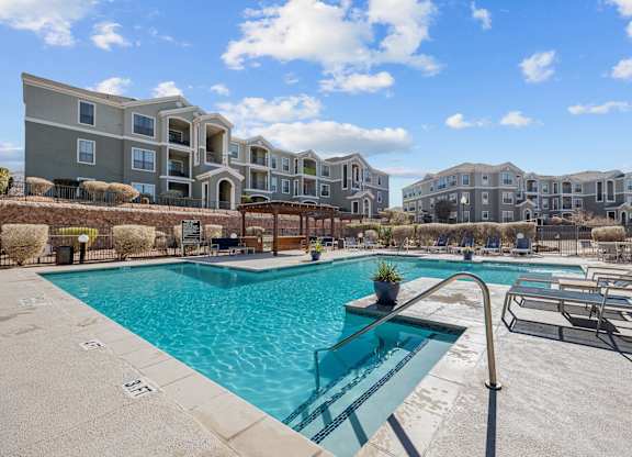 our apartments offer a swimming pool with an apartment building in the background