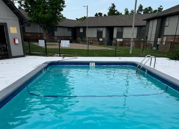 A small empty pool with a blue tiled edge.