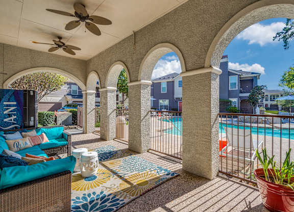 A patio with a pool and a fan.