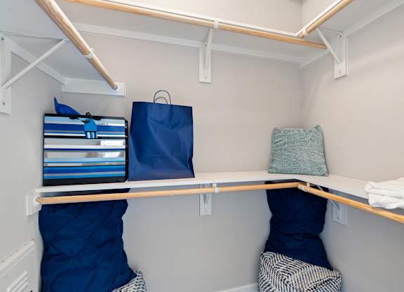 A small room with a bed and a shelf.
