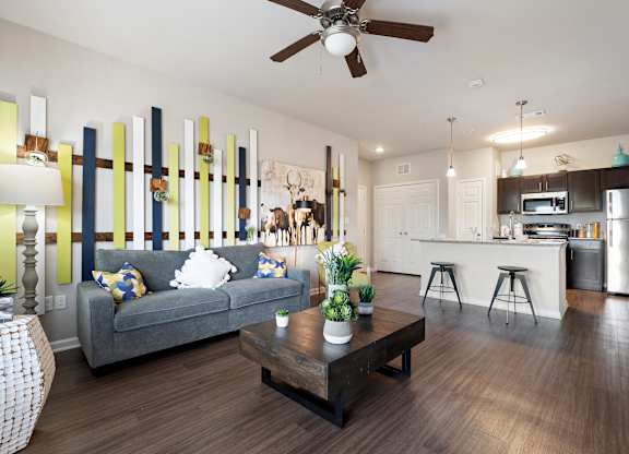 A modern living room with a grey couch and a wooden coffee table.