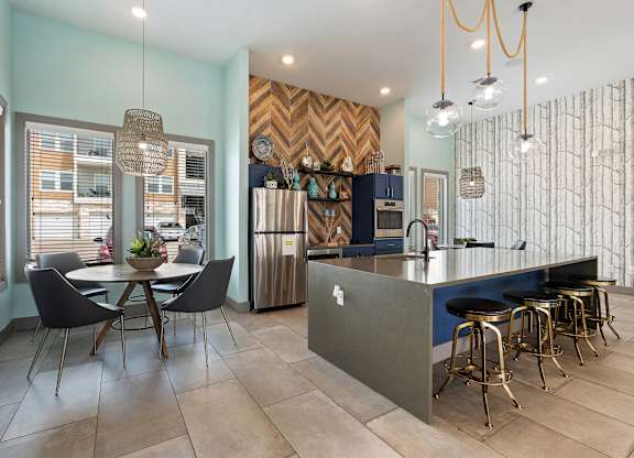 A kitchen with a dining table and chairs.