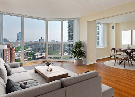 A living room with a grey couch and a wooden coffee table.