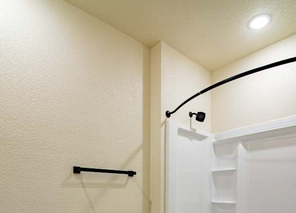 A white toilet sits next to a bathtub in a bathroom.