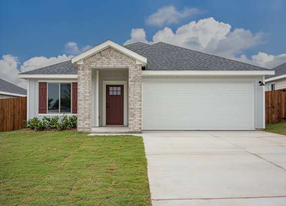 A house with a brown door and a grey roof.